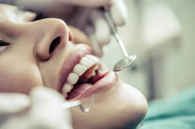 Dentist treats patients teeth